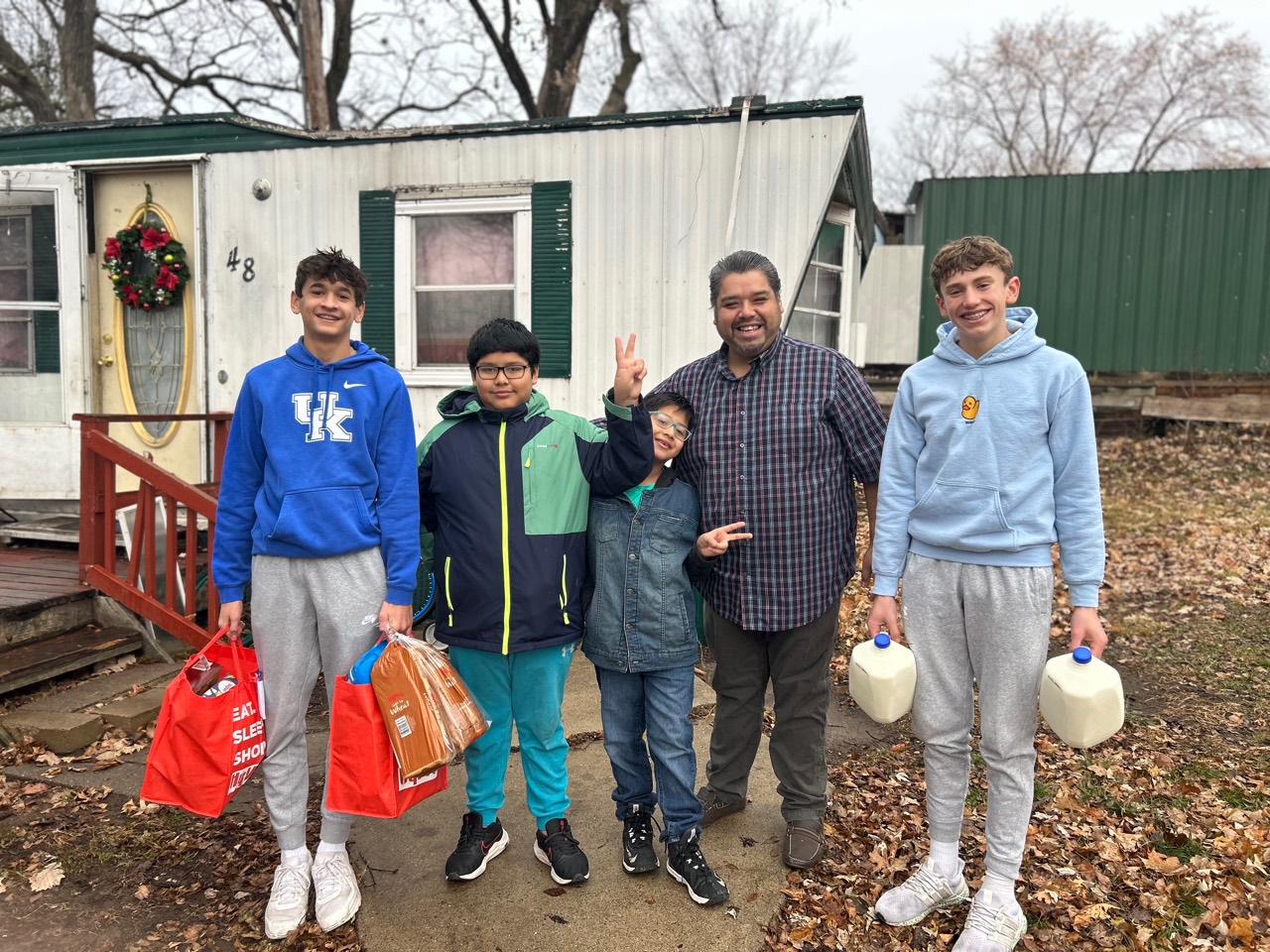 Student volunteers delivering groceries to a Rochester family