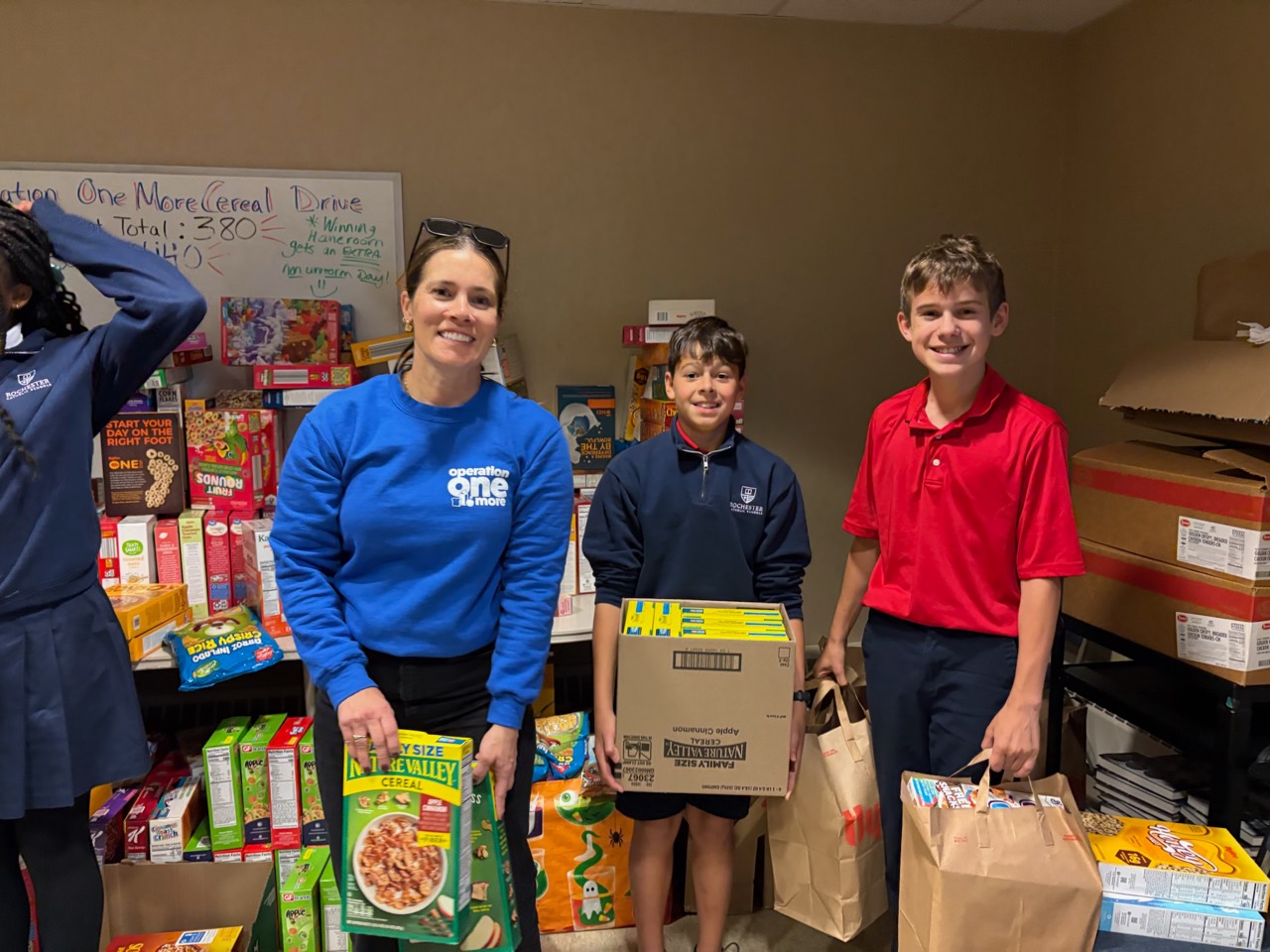 Operation One More volunteers with collected groceries
