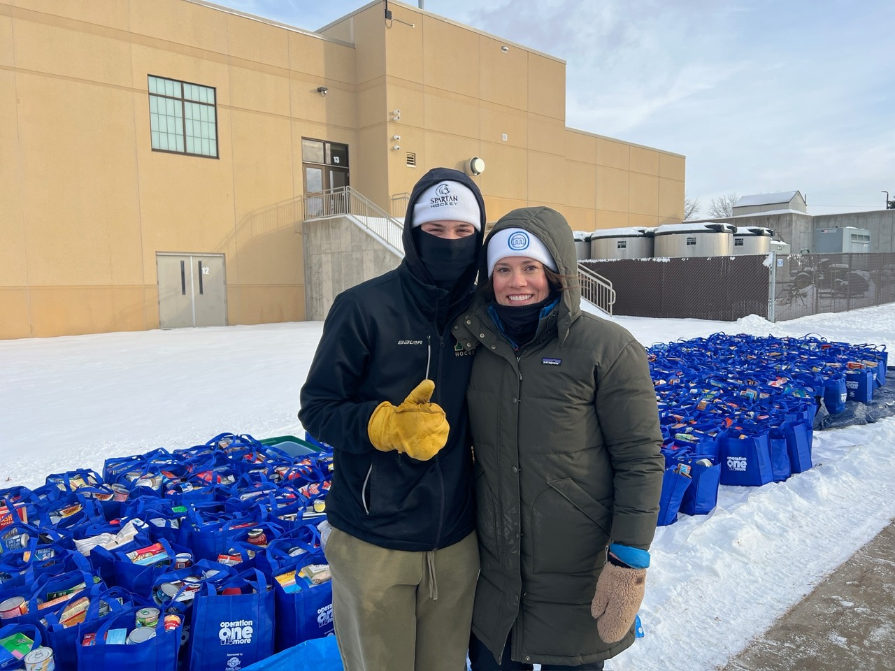 Volunteers with rows of packed grocery bags